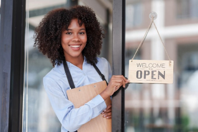 A young woman happy to open her coffee shop 